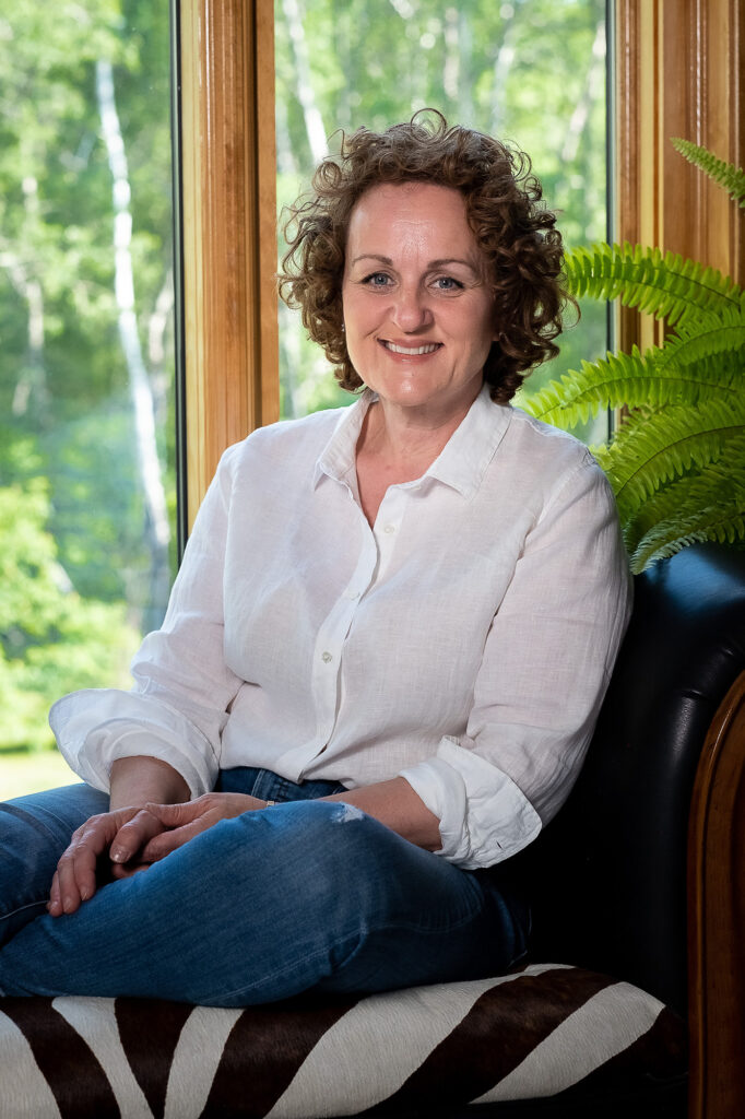 Sonia Acheson is sitting on a bench that has a black and white zebra pattern on it.