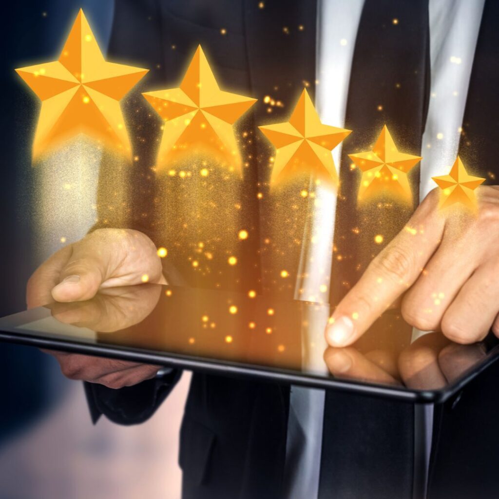 Five stars appearing above a person holding a tablet